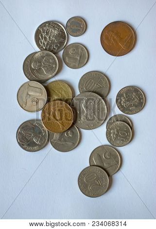 Loose Change, Coins Isolated On White. Multi-currency Coin Intersperses On Background.