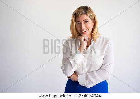 Happy Mature Caucasian Woman Leaning Chin On Hand, Posing And Broadly Smiling At Camera. Company Fou