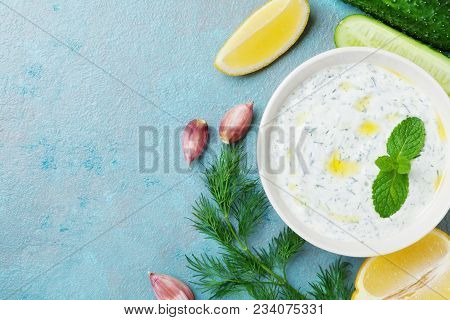 Greek Dip Tzatziki From Sour Cream Yogurt Decorated Cucumber, Garlic, Dill, Lemon And Mint. Top View