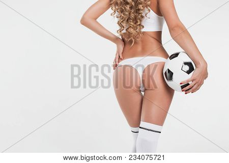 Sexy Beautiful Woman With Long Shapely Legs In White Lingerie, Socks And Boots Posing With A Soccer 