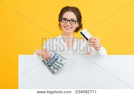 Caucasian Brunette Smiling Attractive Businesswoman In Formal Dress Holding Money And Credit Card In