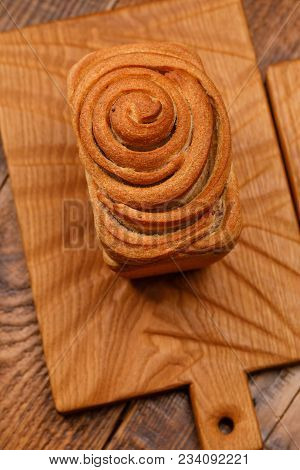 Beautiful Homemade Bread On A Textured Wooden Board. A Beautiful Combination Of The Color Of A Woode