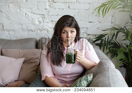 Portrait Of Attractive Plus Size Young Brunette Woman With Curvy Body Hoping To Loose Extra Pounds, 