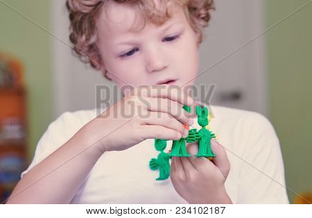 Cute Caucasian Boy In A White Shirt Playing With Colorful Constructor Details. Activities With Child