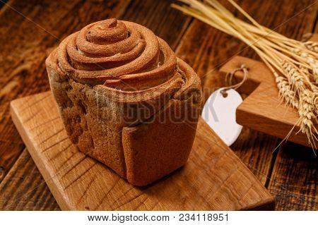 Beautiful Homemade Bread On A Textured Wooden Board. A Beautiful Combination Of The Color Of A Woode