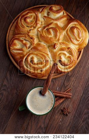 Homemade Rose Bread With Raisins On Wooden Tray, Cup Of Creamy Coffee, Anise And Cinnamon Over Vinta