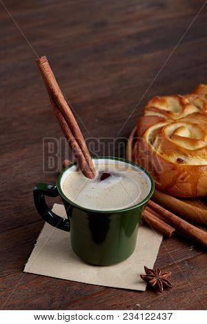 Homemade Rose Bread With Raisins On Wooden Tray, Cup Of Creamy Coffee, Anise And Cinnamon Over Vinta