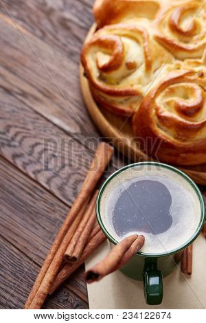 Homemade Rose Bread With Raisins On Wooden Tray, Cup Of Creamy Coffee, Anise And Cinnamon Over Vinta
