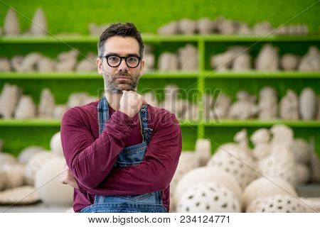 Portrait of Young Ceramist in the Bright Modern Ceramic Workshop. Small Business Concept.