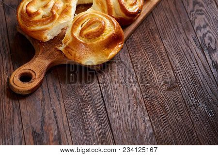 Homemade Rose Buns With Raisins On Wooden Cutting Board Over Rustic Vintage Background, Close-up, Sh
