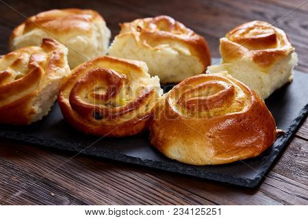 Homemade Rose Buns With Raisins On Wooden Cutting Board Over Rustic Vintage Background, Close-up, Sh