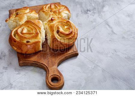 Homemade Rose Buns With Raisins On Wooden Cutting Board Over White Textured Background, Close-up, Sh