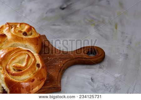 Homemade Rose Buns With Raisins On Wooden Cutting Board Over White Textured Background, Close-up, Sh