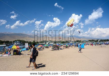 People Enjoy Hot Weather Near Cholpon-ata Beach , Issyk-kul Lake, Kyrgyzstan 30.07.2017