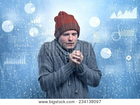 Young businessman shivering with graphs, reports and chart concept