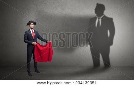 Businessman standing with red cloth on his hand and his shadow on the background