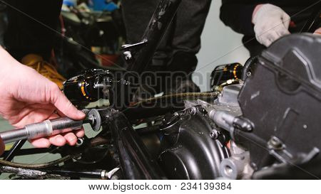 A Team Of Engineers Turns The Nuts With Horn Keys On The Car, Remove The Internal Combustion Engine