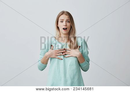 Surprised Terrified Blonde Female Gestures With Uncertainty, Stares At Camera, Puzzled As Doesn T Kn