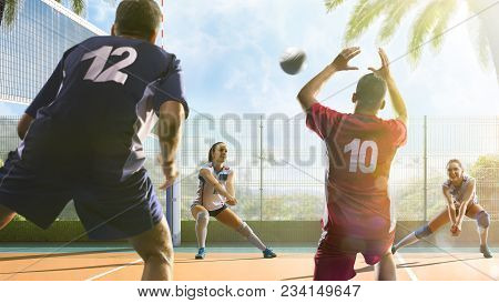Group Of Friends Is Playing Beach Voleyball At Sunny Day