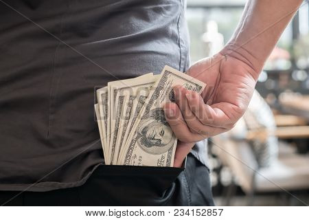A Man Picks Up Us Dollar Banknotes From The Back Pocket.