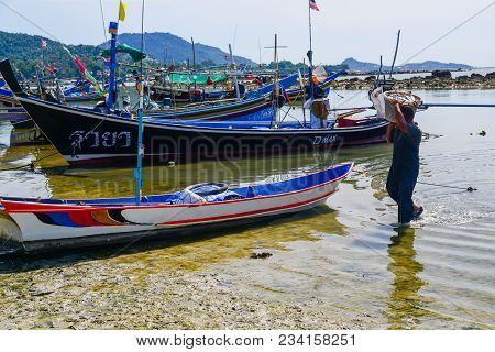 Surat Thani, Thailand - May 25, 2013: Fisherman Carrying Plastic Basket Full Of Fishes On Shoulder W