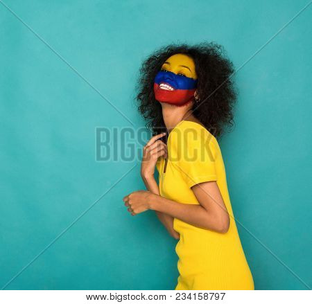Portrait Of A Woman With The Flag Of Columbia Painted On Her Face. Football Or Soccer Team Fan, Spor