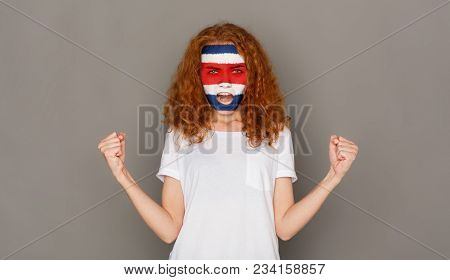 Portrait Of A Woman With The Flag Of Costa Rica Painted On Her Face. Football Or Soccer Team Fan, Sp