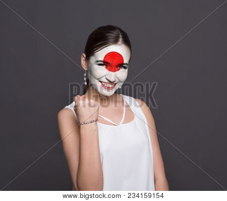 Portrait Of A Woman With The Flag Of Japan Painted On Her Face. Football Or Soccer Team Fan, Sport E