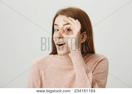 Close-up Portrait Of Interesting Adorable European Redhead Woman Showing Monocle Or Telescope Sign A