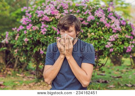 Young Man Sneezes Because Of An Allergy To Pollen.