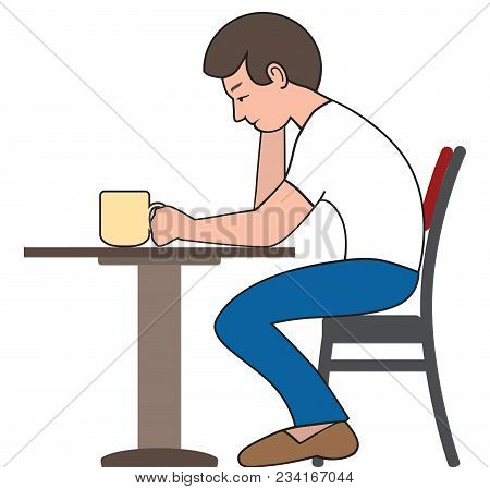 A Young Man Is Sitting At A Small Table Wearily Drinking Coffee
