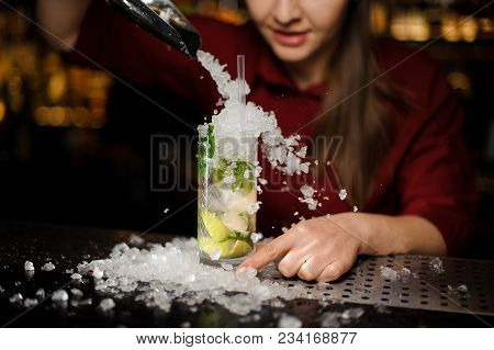 Pretty Barmaid In A Red Dress Adds To Mojito In A Crystal Glass Crushed Ice Using Bar Equipment