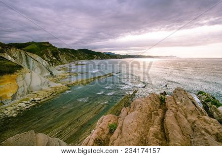 A View To The Coastine Of Basque Country Near Zumaia Fluch With Vibrant Rocks And Dramatic Sunset Sk