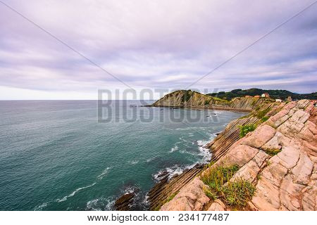 A View To The Coastine Of Basque Country Near Zumaia Fluch With Vibrant Rocks And Dramatic Sunset Sk