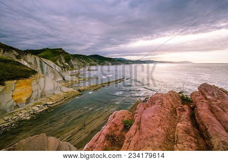 A View To The Coastine Of Basque Country Near Zumaia Fluch With Vibrant Rocks And Dramatic Sunset Sk