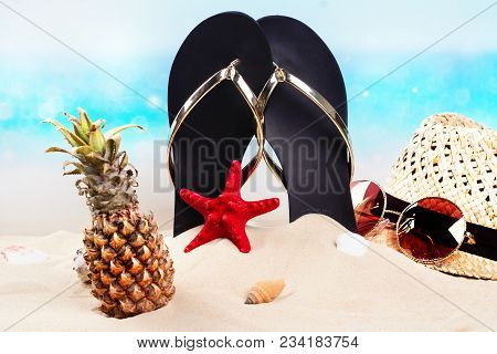 Flip Flops, Hat, Mini Pineapple And Sunglesses On Sandy Beach. Travel, Vacation, Holidays Background
