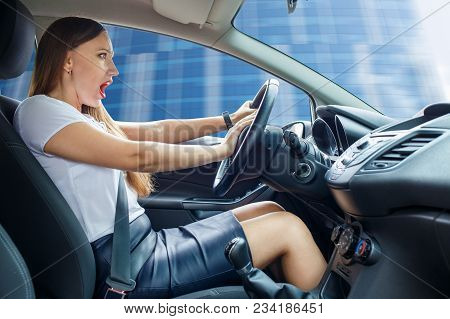 Young Frightened Driver Woman Squealing Brakes Avoiding An Accident