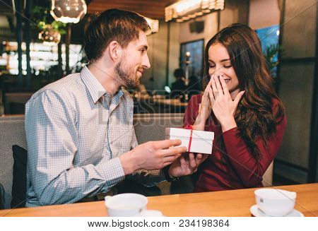 Guy Is Giving His Girlfriend A Gift In White Box. She Didn't Expect That. He Likes To Make His Belov