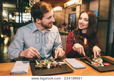 Two Lovely People Are Sitting In Reastaurant And Eating Salads. Also They Are Looking To Each Other 