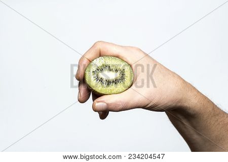 A kiwi fruit cut in the hand