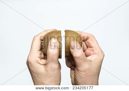 A Kiwi Fruit Cut In The Hand