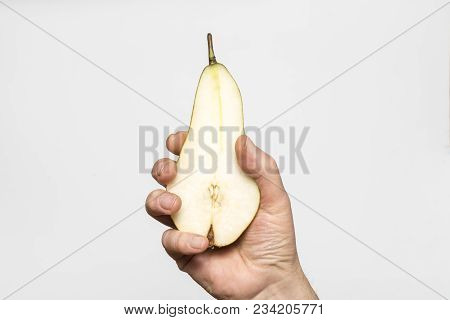 A Pear Fruit Cut In The Hands