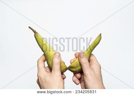 A Pear Fruit Cut In The Hands
