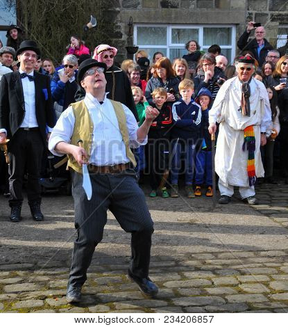 Heptonstall, Uk - March 20 2018: An Actor Juggling Knives In The Traditional Good Friday Pace Egg Pl