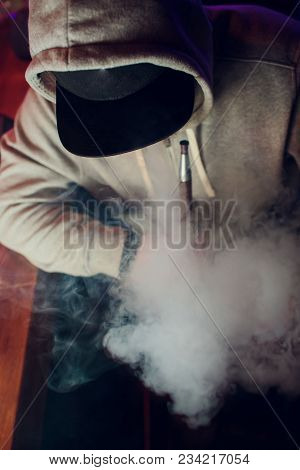 Portrait Of Young Man Smoking An Hookah
