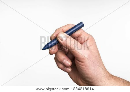 A blue wax crayon in the hand