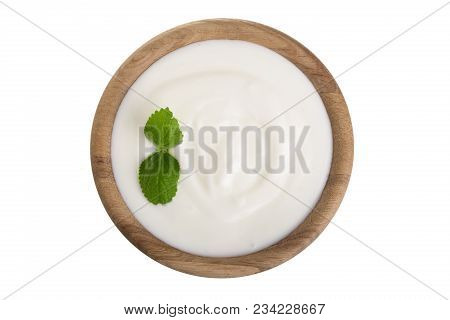 Yogurt In A Wooden Bowl With Mint Leaf Isolated On White Background Top View.