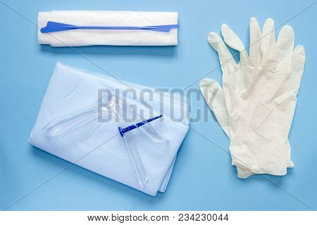 An Overhead Photo Of The Vaginal Speculum, Napkin, Medicine Gloves And Spatula. The Medical Tools Fo