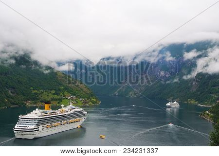 Geiranger, Norway - January 25, 2010: Vacation, Trip, Wanderlust. Cruise Ship In Norwegian Fjord. Pa