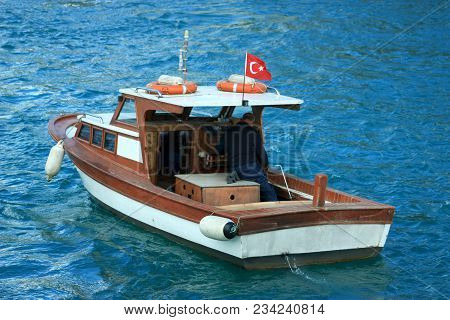 Fisher Boat Floating On Bosporus River In Turkey On Blue Clean Waters